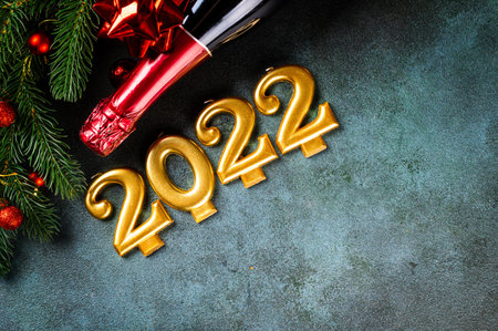 2022 number with champagne bottle and decor. Happy new year and festive concept. Top horizontal view, copyspace. New Year Flatly. Christmas flatlay. New year 2022. New year concept.の写真素材