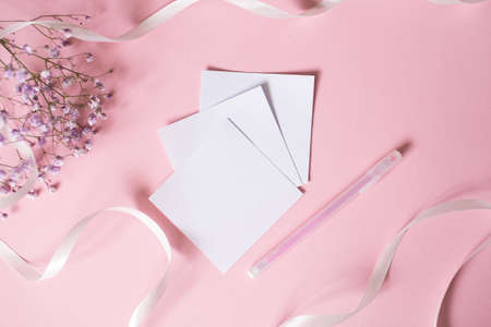 white small flowers, pink background, white ribbon, place for text, vertical