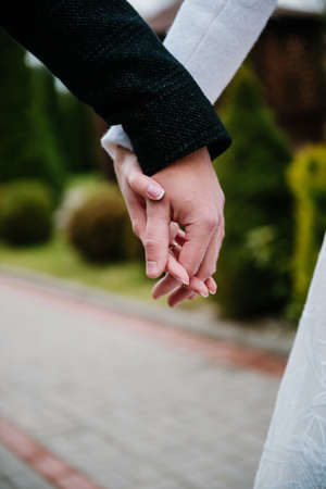 the groom's hand in the bride's handの写真素材