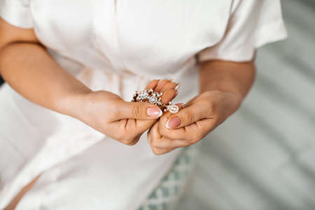 Bouquet for the bride with white roses, which lies on the table next to champagne glassesの写真素材