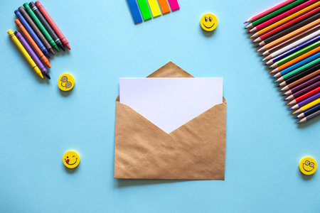 A set of bright stationery on a blue background. Kraft Envelopeの写真素材