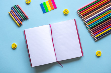 A set of bright stationery items on a blue background. Colour pencilsの写真素材