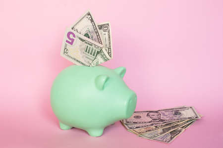 blue piggy bank with 10 and 5 euro notesの写真素材