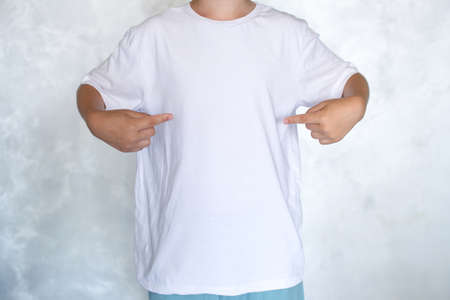 The child is wearing a white T-shirt. Place for advertisingの写真素材