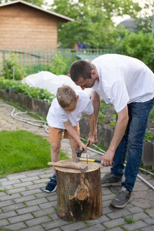 childhood, summer holidays, fatherhood, fatherhood, father and son, roof garden, village life, candid moment, man doing household chores, hobbies and leisure, nails, hammer, hammer nails, men's activitiesの写真素材