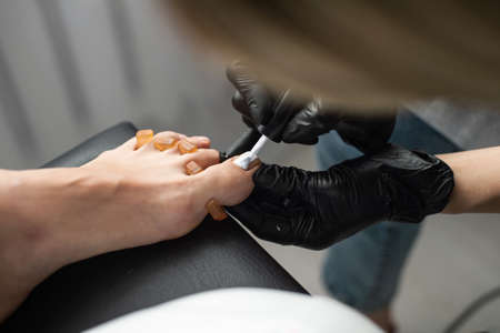 Beautiful salon procedure with pink pedicure on towel background.の写真素材