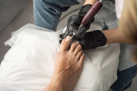 Beautiful salon procedure with pink pedicure on towel background.の写真素材
