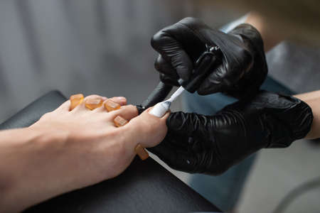Beautiful salon procedure with pink pedicure on towel background.の写真素材