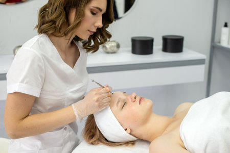 A teenager treats the skin of the face. Cosmetic procedures. Sterile medical instrumentの写真素材