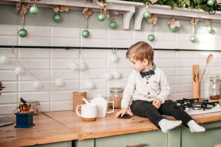 kitchen set, kitchen table, boy on the table, christmas holidays, sitting on the table, family...