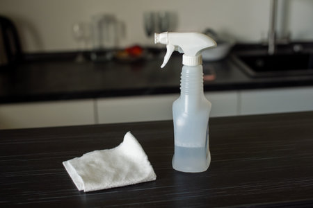 Spray an aerosol to clean the countertop. Wipe the table with a white clothの写真素材