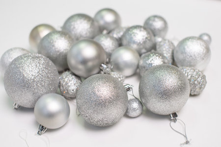 A set of silver Christmas tree toys and decorations for the holiday lie on a white backgroundの写真素材