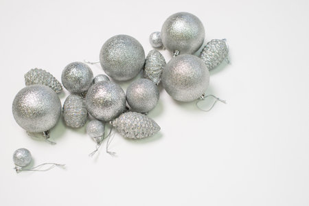 A set of silver Christmas tree toys and decorations for the holiday lie on a white backgroundの写真素材