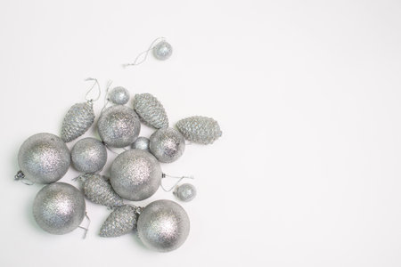A set of silver Christmas tree toys and decorations for the holiday lie on a white backgroundの写真素材