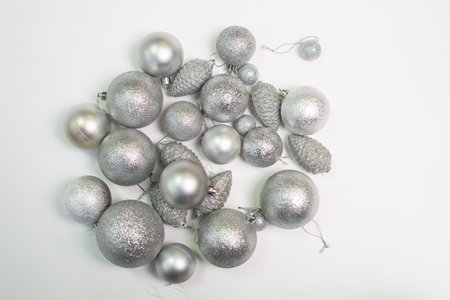 A set of silver Christmas tree toys and decorations for the holiday lie on a white backgroundの写真素材