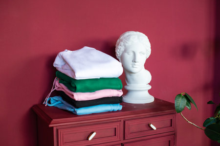 Multicolored things are folded on the bedside tableの写真素材