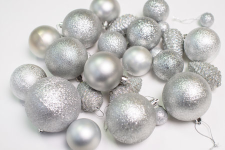 A set of silver Christmas tree toys and decorations for the holiday lie on a white backgroundの写真素材