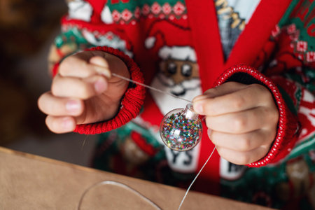 Transparent Christmas tree ball in your handsの写真素材