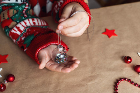 Transparent Christmas tree ball in your handsの写真素材