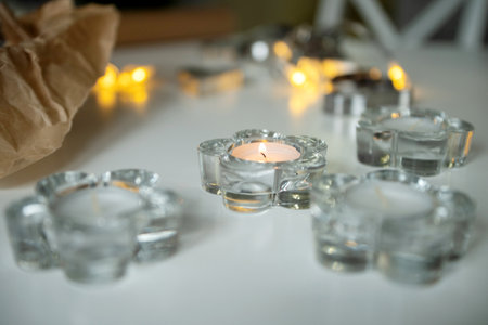 festive candles in a glass candlestick in the shape of a flowerの写真素材