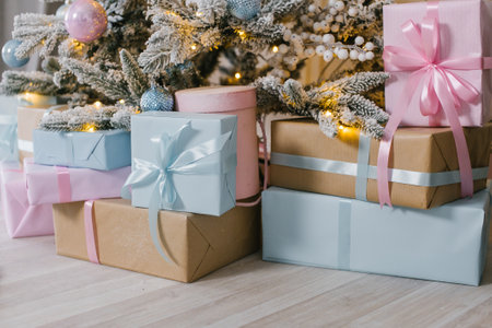 Gift boxes under the Christmas tree , blue and pink packages with bowsの写真素材