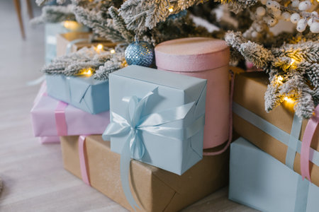 Gift boxes under the Christmas tree , blue and pink packages with bowsの写真素材
