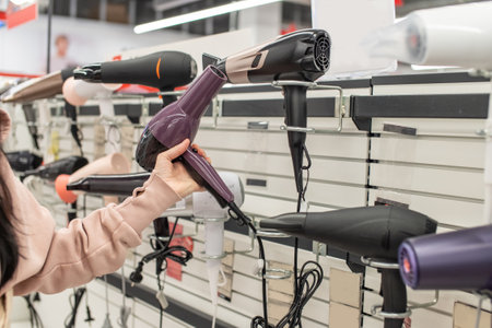 Holding a hair dryer in your hands from a shop windowの写真素材