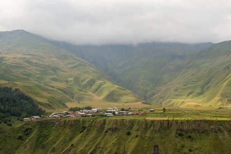 Mountainous terrain on the Georgian military road. Clouds over the mountainsの写真素材