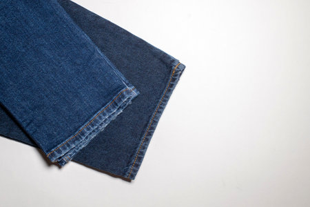 Close-up detail of the background texture of the fabric of blue jeans. The lower part of the...