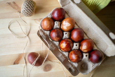 Painted eggs cooked for Easter are in an eco-friendly tray near the towelの写真素材