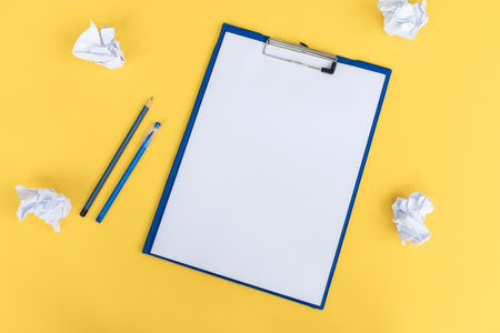 A blue stationery set as a template with a place to copy on a yellow background. Crumpled paperの写真素材