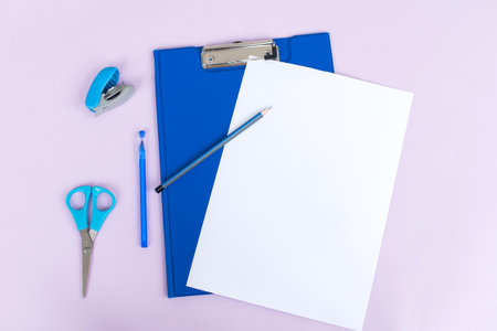 Clipboard with a white sheet and a pen highlighted on a light background. Top viewの写真素材