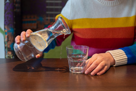 Pour water from the jug on the table. My hands are shaking