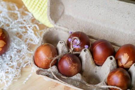 Painted eggs cooked for Easter are in an eco-friendly tray near the towelの写真素材