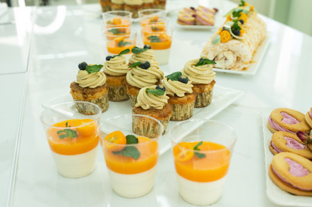 Desserts for the holiday, cupcakes with cream, panna cotta, cookies and marshmallows