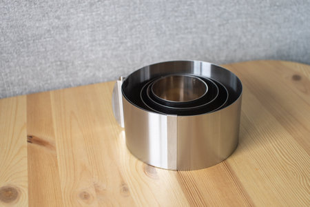 A set of tools for a confectioner. Round molds for baking cakes of different sizes on the table