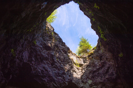 Ruskeala Mountain Park, Republic of Karelia. Through hole in the cave, view of the skyの写真素材