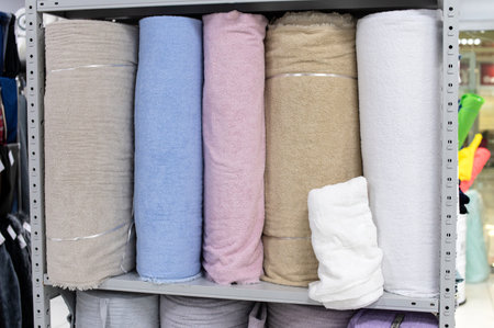 Assortment of fabrics in the store. Shelf in a store with mohair material different colors. textile materials for sewingの写真素材