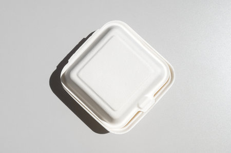 A closed white cardboard box for a bento cake to take away, highlighted on a white background. Disposable Food Packaging box, containerの写真素材