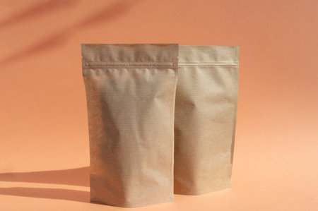 Two craft paper bags with a zipper in the background. The layout of the bag-bag on an orange...
