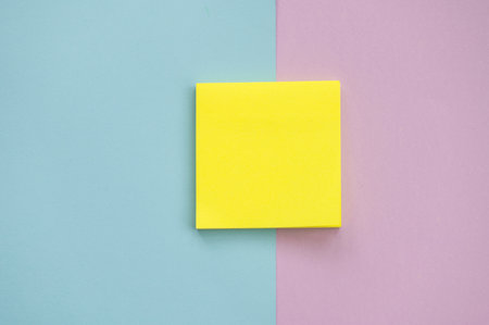Top view of yellow sheets of stickers on a blue and purple background Mockup with a notebook ,...