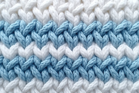 Banner with macro photography of the texture of a knitted pattern in close-up, white and blue colors, warm clothesの素材