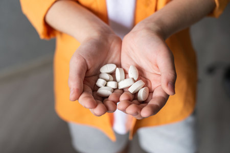 Children's hands hold a large number of pills in their palms. Sprinkle vitaminsの写真素材