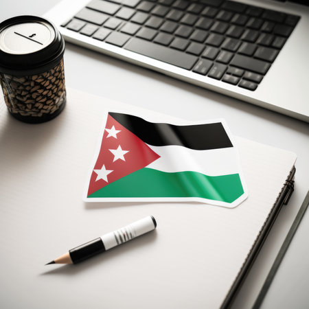 Sticker of the Palestine flag on a laptop, with pens and a notebookの素材