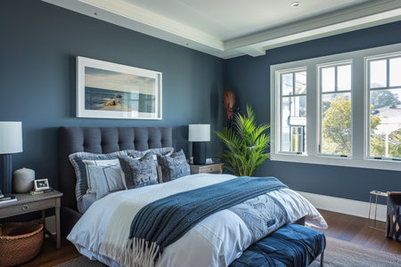 A luxurious bedroom with dark blue walls, a comfortable bed, and tasteful decorの素材