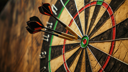 Close-up image of a dartboard with darts hitting the bullseye, symbolizing successの素材