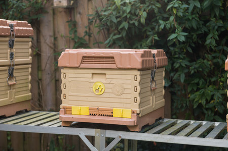 A compost bin placed on a wooden table in a lush gardenの写真素材