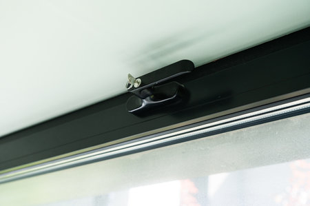 Window handle with a secure lock with a key. Black window frameの写真素材