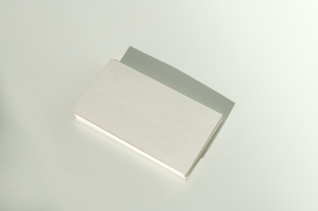 White blank business card on brown paper background with soft shadow. Corporate identity and stationery mockup concept with copy spaceの写真素材
