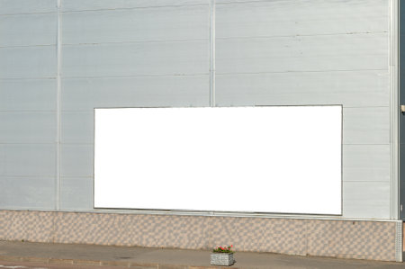 Billboard layout on the wall of the building. Gray city building with a billboard. Place for text. Copy space on a buildingの写真素材